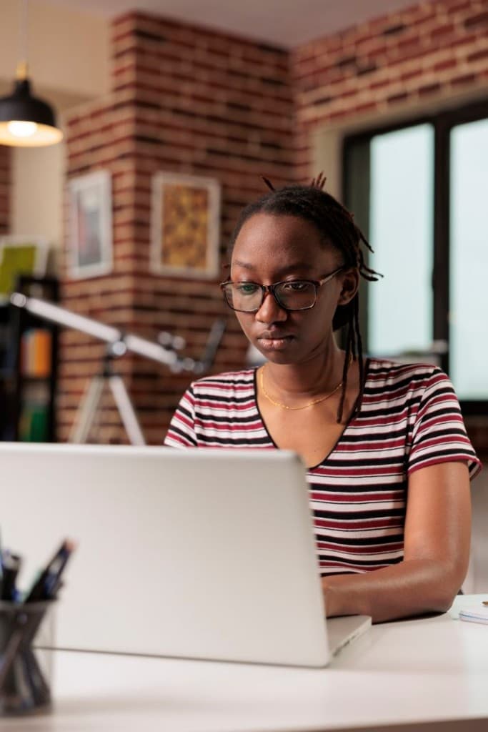 Professional focused on practical work at her laptop